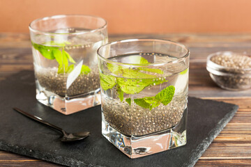 Healthy breakfast or morning with chia seeds and mint on table background, vegetarian food, diet...