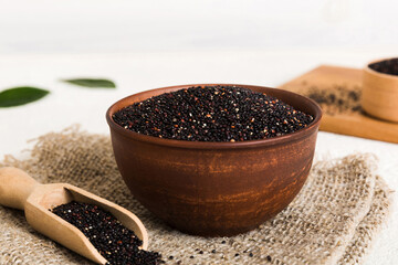 quinoa seeds in bowl and spoon on colored background. Healthy kinwa in small bowl. Healthy superfood
