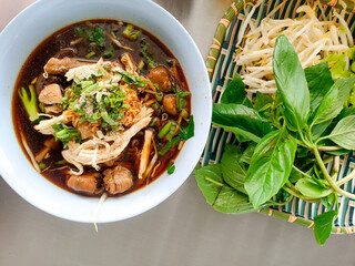 The steaming bowl of noodles sits invitingly on the table, filling the air with a savory aroma.