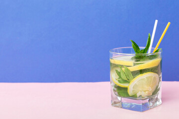 Mojito summer refreshing cocktail with ice and mint. mojito cocktail with lime, lemon and mint in a tall glass with a stick