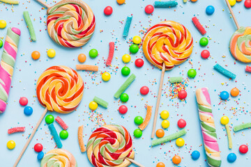 Tasty appetizing Party Accessories Happy Birthday Sweet. Different types of candies on colored background, copy space. Colorful birthday party background