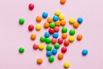Mixed collection of colorful candy, on colored background. Flat lay, top view. frame of colorful chocolate coated candy