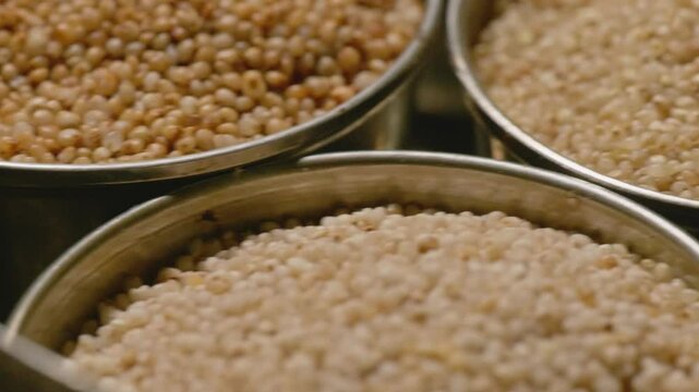 types of healthy millet grains, stored in the steel bowls, 4k, close up shot
