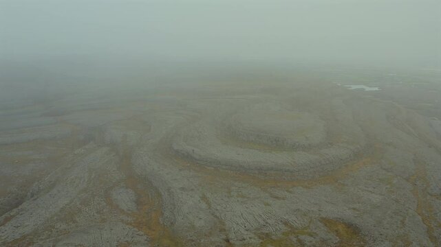 Aerial view of iconic Burren peaks fading into misty skies. Ireland
