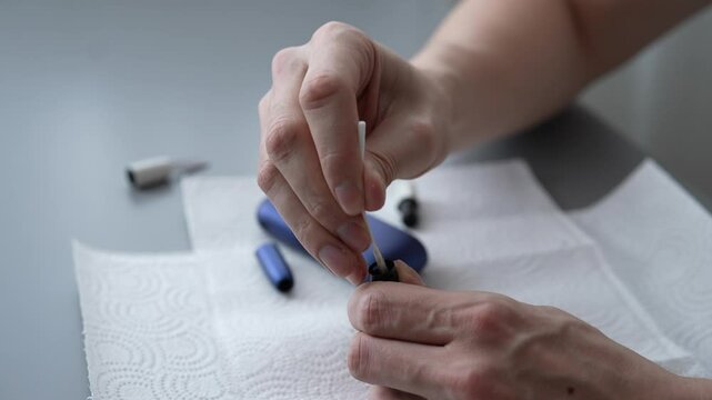 Meticulously cleaning iqos device with cotton swab, ensuring both hygiene and optimal performance for electronic cigarette, maintaining cleanliness for optimal heat-not-burn tobacco performance.