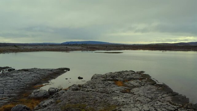 Low tracking shot over Burren's seasonal lake, County Clare, Ireland.