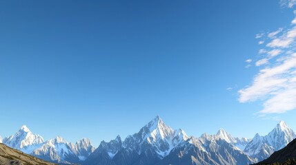 Snow capped mountain range under a clear blue sky