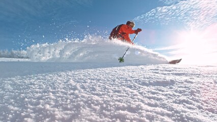 Free Ride Skier Running Down the Hill. Freeze Motion. Powder Snow Exploding.