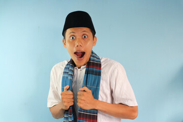 Asian Muslim man wearing cap and sarong with wow expression