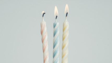 Birthday Candles: Three colorful spiral birthday candles stand tall and ready to be lit, representing the joy and celebration of another year.