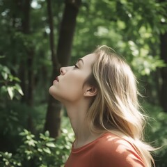 Fototapeta premium Profile of a relaxed woman breathing fresh air in a green forest 