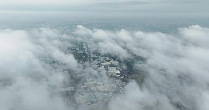 Aerial view of Saigon cityscape at morning with misty sky in Southern Vietnam. Urban development texture, transport infrastructure and green parks