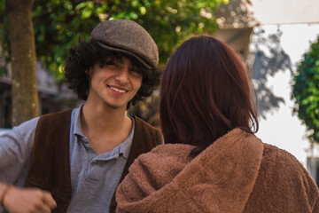 Frustrated mixed-race young couple having argument and quarrelling with each other outdoors in the...
