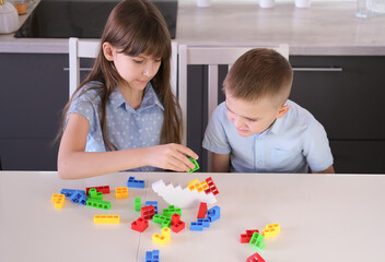 Fototapeta premium Children playing balancing board game. Family spending time together at home enjoying intellectual logic games.