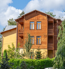 Wooden balcony of a wood house. Exterior facade windows. Old architecture city. Ukraine