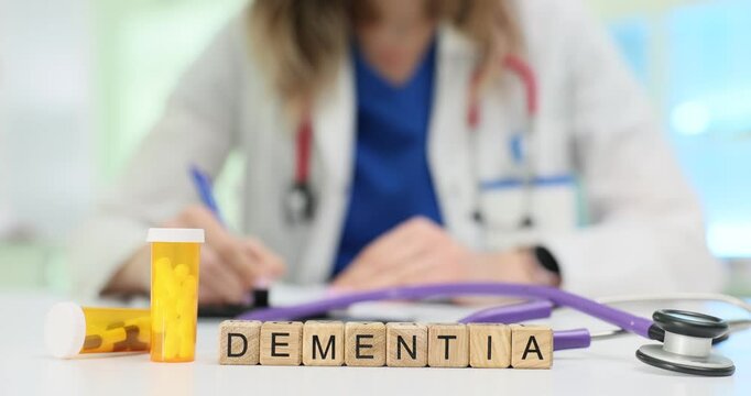 A healthcare professional writes a dementia prescription, showing various medical tools used in the process