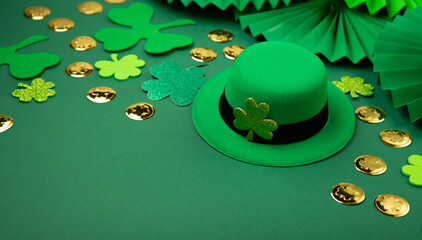 St. Patrick's Day Leprechaun Hat, Gold Coins, Shamrocks and Party Favors on Green Background.