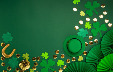 St. Patrick's Day Leprechaun Hat, Gold Coins, Shamrocks and Party Favors on Green Background.
