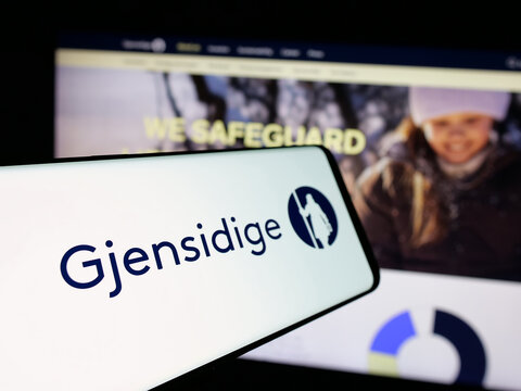 Stuttgart, Germany - 01-14-2025: Mobile phone with logo of Norwegian company Gjensidige Forsikring ASA on screen in front of business website. Focus on center-left of phone display.