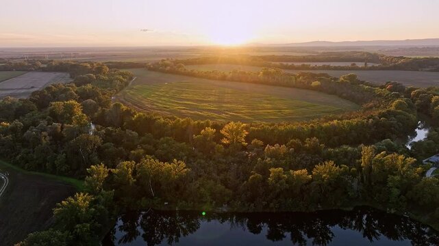 Beautiful sunset over Slovakia country with lake, field,  village and forest. Aerial view at sunset. Hruby Sur