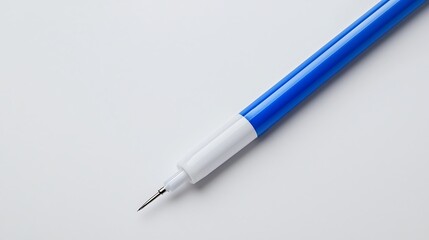 Fototapeta premium A close-up image of a blue pen with a white grip, showcasing its fine tip against a minimalist white background.