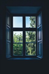 Fototapeta premium A window with a view of trees outside, offering a serene and calming ambiance through natural light and fresh air.