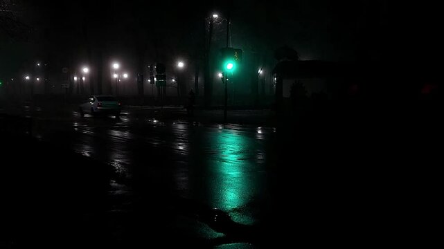 reflection on the road from car headlights and traffic lights at night in fog and rain in autumn. Poor visibility on the road, background