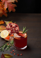 Red berry drink made from pomegranate and citrus in a glass mug