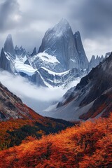 Mountains, dramatic landscape featuring peaks and valleys surrounded by mist, with vibrant autumn foliage in the foreground, ideal for nature and travel enthusiasts.