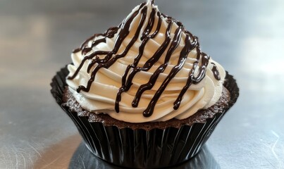 A beautifully decorated cupcake featuring fluffy frosting swirled with chocolate drizzle