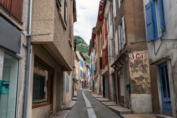 A narrow alleyway with a cobblestone street and a few shops
