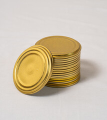 Iron gold metal lids on jars on light background