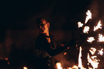 fireshow artist woman dancing, young caucasian beautiful sportive woman makes perfomance with fire...