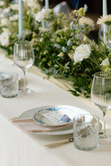 Modern stylish wedding table setting. The wedding decor. The pastel colors flowers bouquet. Natural beautiful wedding decorations. Minimalistic wedding decorations