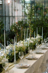 Modern stylish wedding table setting. The wedding decor. The pastel colors flowers bouquet. Natural beautiful wedding decorations. Minimalistic wedding decorations