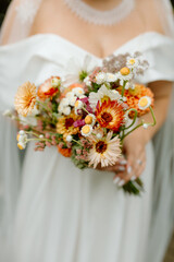 Modern stylish wedding bouquet of wild flowers. The wedding decor. The pastel colors flowers bouquet. Natural beautiful wedding decorations. Minimalistic wedding decorations