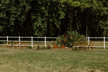 Authentic stylish Wedding ceremony decorations in epic scenery. Wild flowers. The wedding decor....