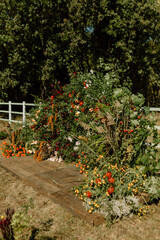 Authentic stylish Wedding ceremony decorations in epic scenery. Wild flowers. The wedding decor. The autumn ethno colors flowers bouquet. Natural beautiful wedding decorations. Autumnal