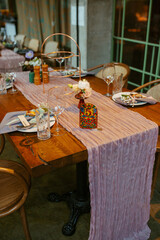 Modern stylish wedding table setting. Fairytale wedding decoration. Vibrant colors, vintage style. The pastel colors flowers bouquet. Natural beautiful wedding table setting  