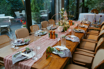 Modern stylish wedding table setting. Fairytale wedding decoration. Vibrant colors, vintage style. The pastel colors flowers bouquet. Natural beautiful wedding table setting  
