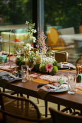 Modern stylish wedding table setting. Fairytale wedding decoration. Vibrant colors, vintage style. The pastel colors flowers bouquet. Natural beautiful wedding table setting  