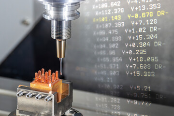 Abstract scene the CNC milling machine cutting the copper electrode parts and G-code data...