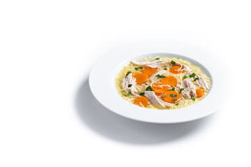 Homemade chicken soup with carrot isolated on white background. Copy space