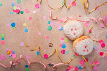Fototapeta premium Colorful carnival or party background with donuts, streamers and confetti