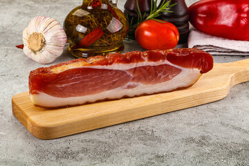 Piece prosciutto crudo over board