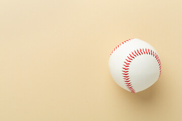 Baseball ball on color background, top view