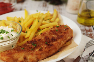 Fish and chips served on the plate, traditional dish of Great Britain	