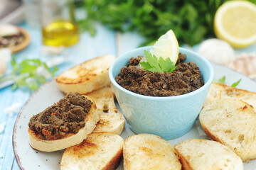 A bowl with tapenade - traditional olive dip in Mediterranean region	