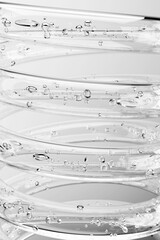 Transparent 3D spiral with bubbles, on a gray background with a place for text. Vertical. The...