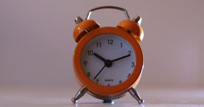 Orange The clock sets the time to 10.00. on white background 4k
